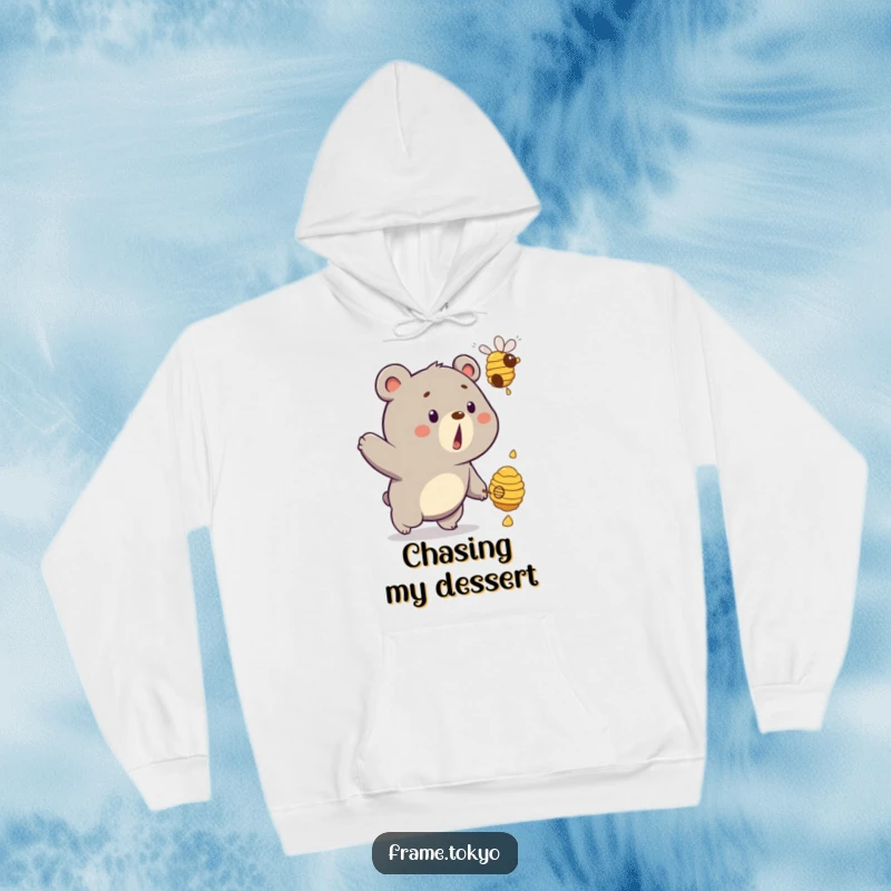 Funny bear hoodie depicting a startled bear with a dripping beehive floating away, a humorous chase scene.